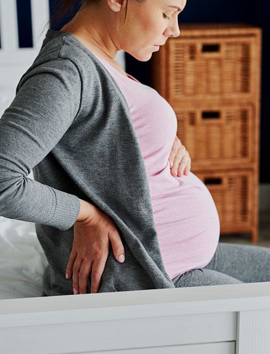 pregnant woman with back pain prenatal chiropractic