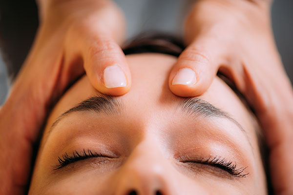 woman getting head massaged